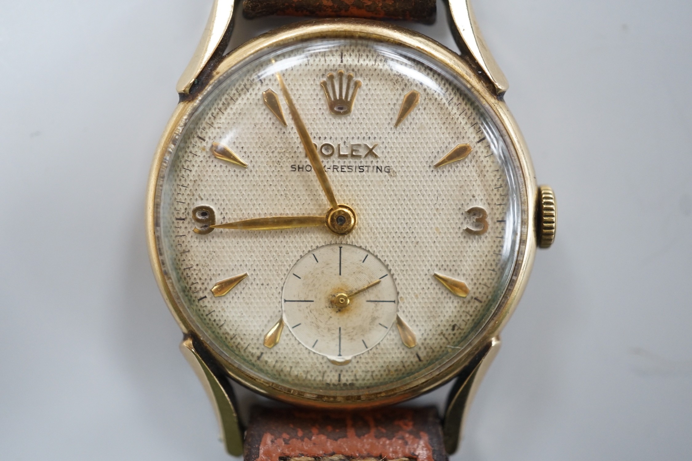 A gentleman's mid 1950's 9ct gold Rolex shock-resisting manual wind wrist watch, with baton and Arabic numerals and subsidiary seconds, on later associated leather strap, case diameter 32mm